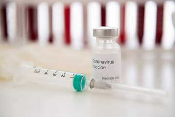 Test tubes with blood sample Covid-19 coronavirus. Vaccine and syringe injection It use for...