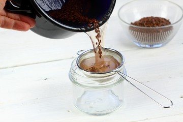 Making natural hair setting lotion for perfect hair. ..Boiled flax seeds filtered into a jar....