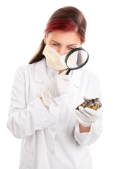 Young veterinarian examining a turtle with magnifying glass
