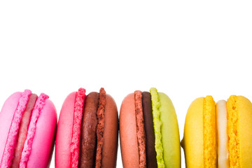 Stack of french colorful macaroons in row isolated on white background