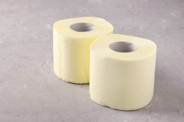 Two rolls of soft toilet paper on gray background, High unexpected demand, Deficit, Covid-19 pandemic