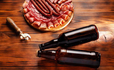 Beer snack in the form of meat products and bottled beer. Appetizer in the form of slicing bacon,...