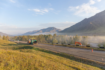 Road constructionin altai, Russia. Misty morning landscape