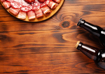 Beer snack in the form of meat products and bottled beer. Appetizer in the form of slicing bacon,...