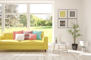 White living room with sofa and summer landscape in window. Scandinavian interior design. 3D illustration