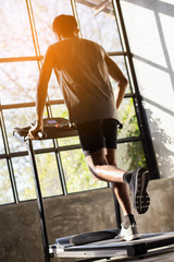 Young men exercise on an automatic treadmill