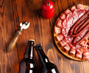 Beer snack in the form of meat products and bottled beer. Appetizer in the form of slicing bacon,...