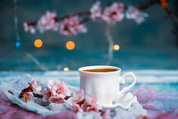 Cup of coffee and spring cherry blossom flowers