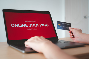 Hands holding credit card and use for shopping payment online on laptop, shopping online concept.