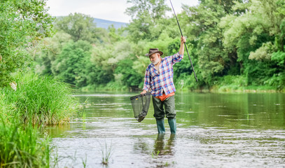 retirement. mature man fly fishing. man catching fish. fisherman with fishing rod. hobby and sport activity. pothunter. retired bearded fisher. Trout bait. summer weekend. Big game fishing