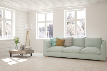 White living room with sofa and winter landscape in window. Scandinavian interior design. 3D illustration