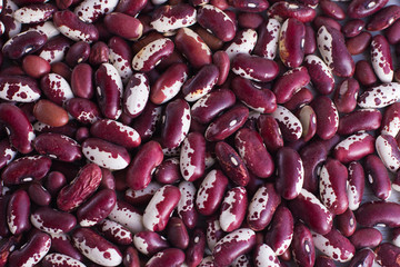 Red kidney beans close background. Healthy source of protein nutrition. Vegetarian-based vegan diet. Emergency stocks - background. Ingredient of indian and mexican cuisine for chili con carne