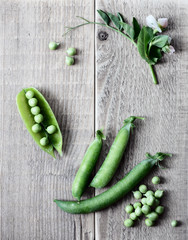 Peas on wooden rustic textured background, closeup, flat lay, from above overhead top view, vegan food and healthy organic food concept