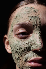 Fototapeta premium Woman face with organic cosmetic green mask. Cosmetology , beauty and spa