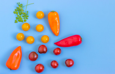 Set fresh vegetables,  tomatoes, peppers on a blue background.  Healthy food concept. Flat lay, top view.