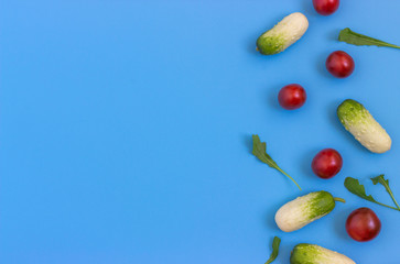 Set fresh vegetables, cucumber, tomatoes on a blue background.  Healthy food concept. Flat lay, top view. Copy space for text