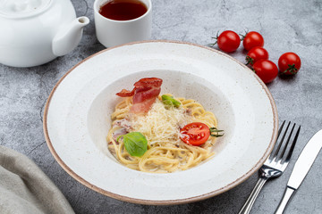 Traditional carbonara with egg creamy sauce and crispy bacon