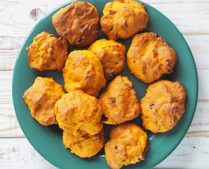 Pumpkin cookies with raisins on a white wooden background. The view from the top.