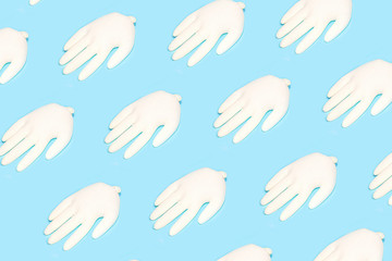 Concept of prevention from coronavirus with rubber latex gloves on blue background.