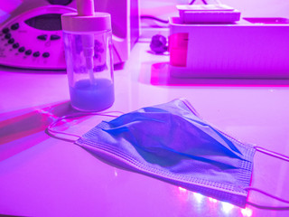 Coronavirus prevention medical surgical masks hand sanitizer under uv light with lab equipment corona virus protection II