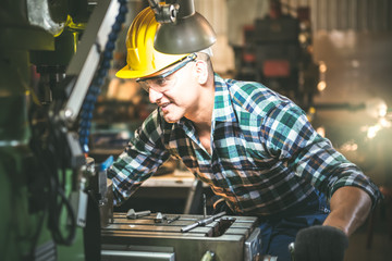 Close up images of Experienced operator Caucasian male technician Working diligently to get quality work pieces At the machine In industrial factory to professional worker manufacturing concept