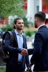 Business men shaking hands, starting up a meeting. Elegancy and male style