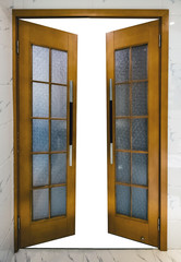 Opened wooden door with glass and handle on wall