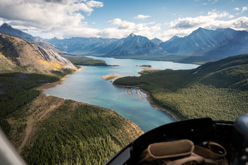 Inside of helicopter flying on rocky mountains with colorful lake © Mumemories