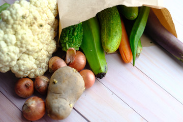 fresh vegetable in a shopping bag board on kitchen table 