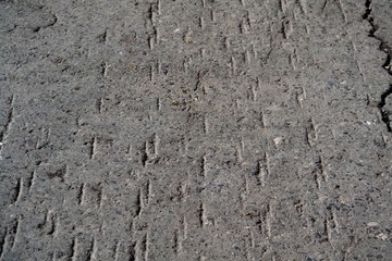 Asphalt covered with flaws. Photo background