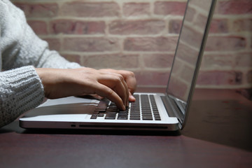 close up of women hand use laptop indoor 