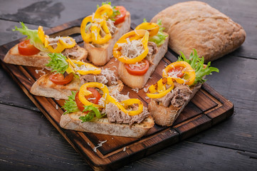 Canapes with pate, grilled sweet pepper, cherry tomatoes, lettuce and cheese. Tasty snack