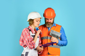 how new home is being built. Worker show house design. couple discussing blueprint at home. real estate deal. talk about interior decoration. under construction. looking at construction house plan