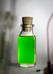 Green potion in a glass bottle