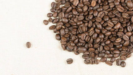 coffee beans.coffee beans sprinkled on fabric.