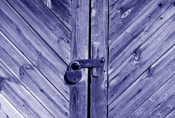 Wooden door with lock in blue tone.