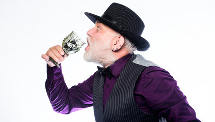 Delicious cocktail for brave man. Bearded old guy hold wineglass with spider inside. Extreme lifestyle. Exotic food. Cocktail with real spiders. Alcohol drink and bar. Bartender enjoy weird cocktail