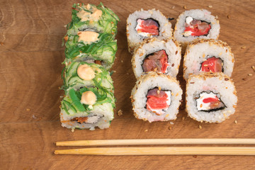 Sushi rolls on a wooden board (delicious food)