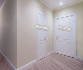 Two white doors light corridor with an quarantine sign. Sign of self-isolation pandemic period.