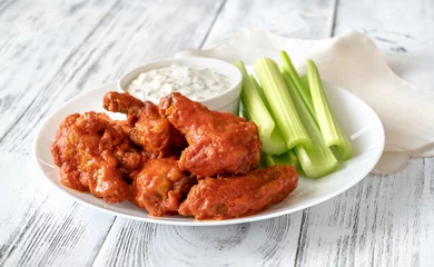 Fototapeten Bowl of buffalo wings with blue cheese dip © alex9500