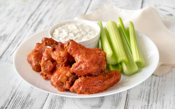 Bowl of buffalo wings with blue cheese dip