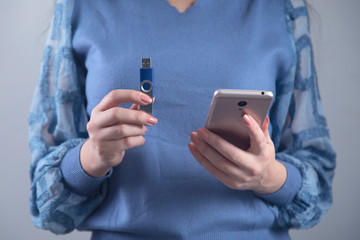 woman hand flash drive and phone