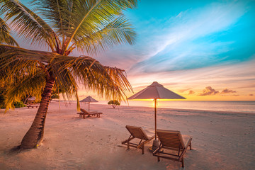 Sunset tropical beach landscape. White sand and coco palms wide panorama background concept. Amazing beach sunset use for summer vacation and exotic holiday, luxury travel tourism destination
