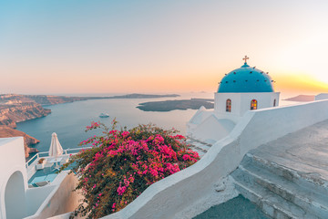 Summer landscape, travel, vacation. Sunset view of traditional cycladic houses with flowers in...