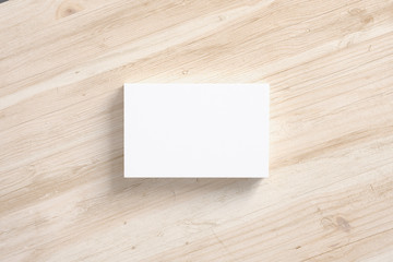 Blank business cards stack on wooden desk background top view as template for design presentation, promotion etc.