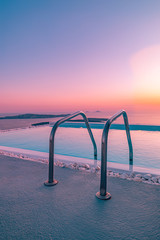 Amazing sunset view from infintity pool, Santorini, Greece as luxury travel and vacation destination. Twilight sky and beautiful view 