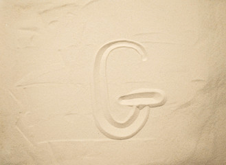  letters of the English alphabet drawn in the sand