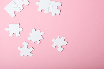 White puzzle on a colored background top view.