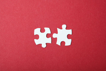 White puzzle on a colored background top view.