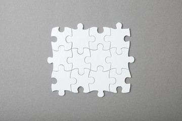 White puzzle on a colored background top view.